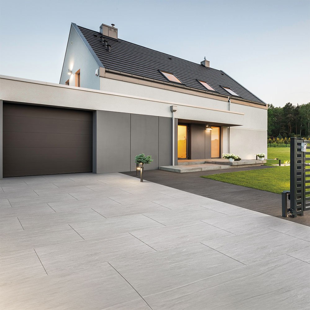 Contemporary exterior with large-format pale paving and a defined entrance